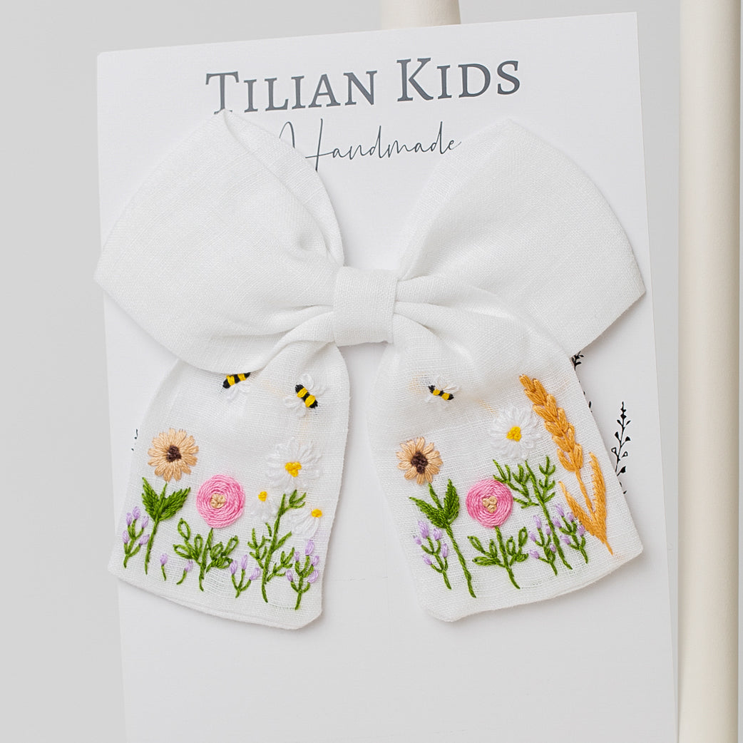 Handcrafted Blossom Embroidered Hair Bow with delicate floral and bee stitching on soft cotton yarn, perfect for an elegant accessory.