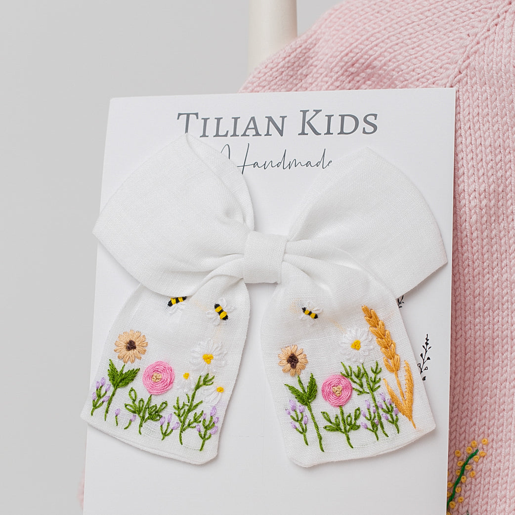 Blossom Embroidered Hair Bow with intricate hand embroidery on cotton yarn, inspired by British countryside florals and bees.
